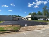 A large building with a parking lot in front of it