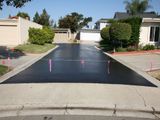 A black driveway with pink markers on it