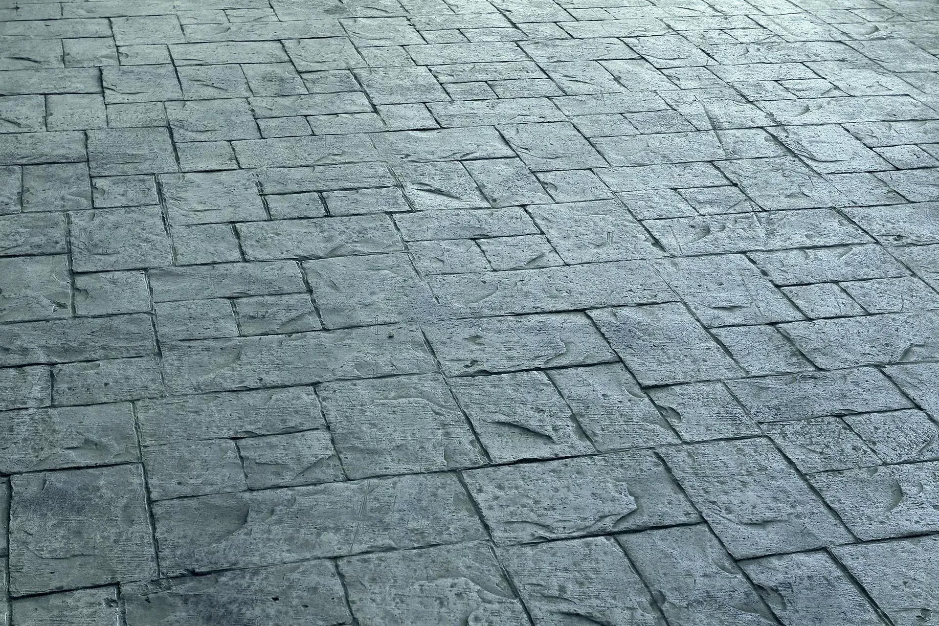 A close up of a brick floor with a geometric pattern.