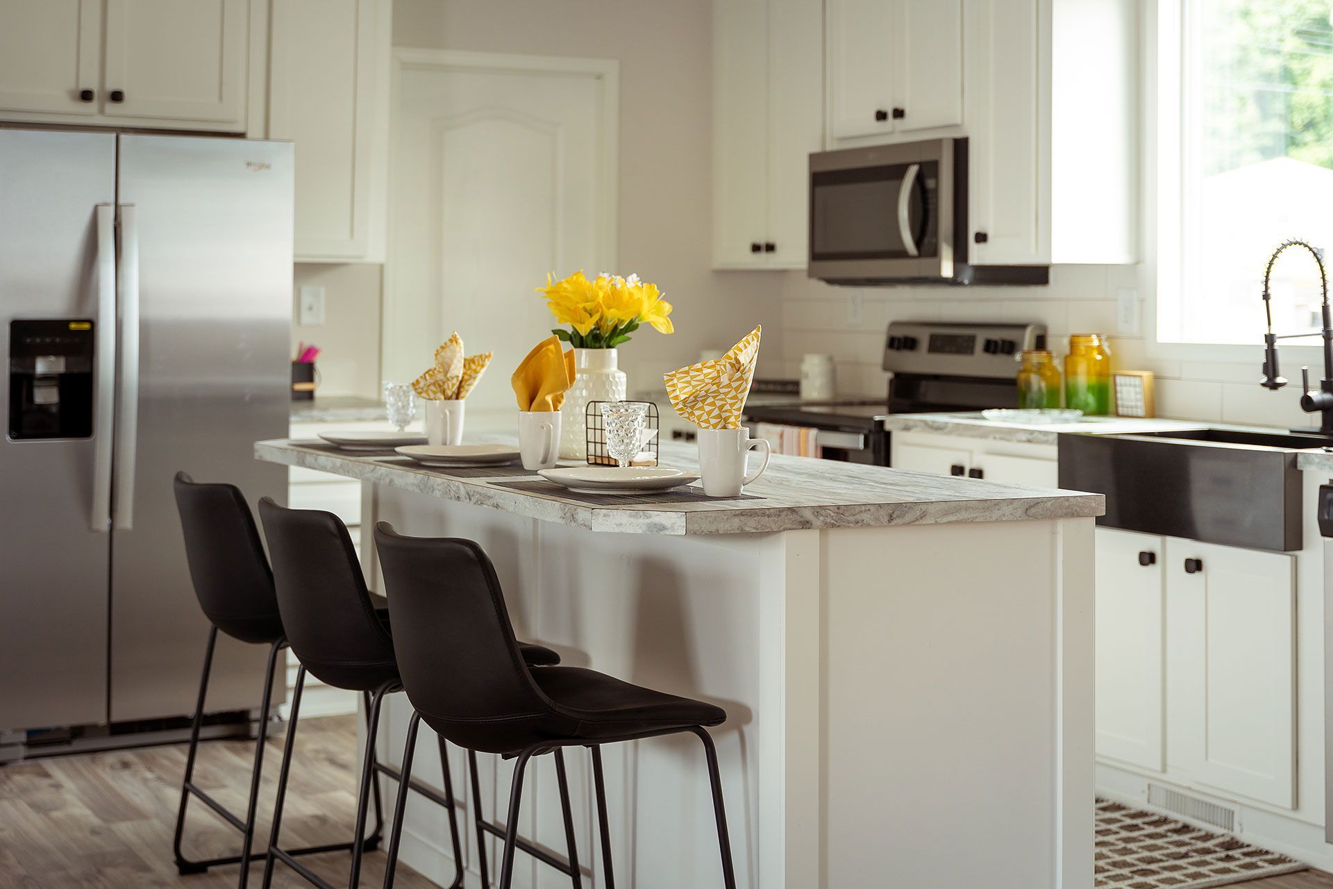 kitchen with white island counter with high chairs