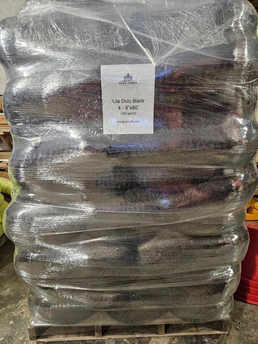 A pallet of wrapped black bags, labeled 