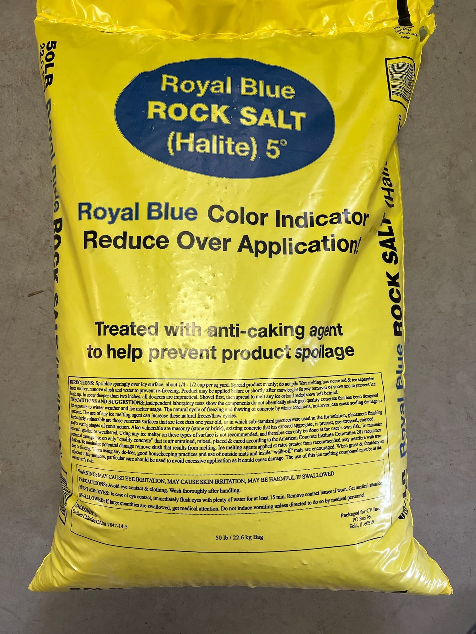 Yellow bag of Royal Blue rock salt, with blue text and a label indicating its use as a de-icer.