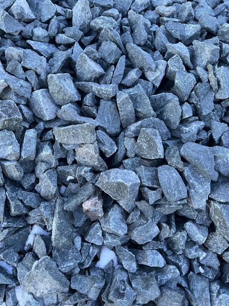 Pile of blue-gray crushed stone with various shapes and sizes.