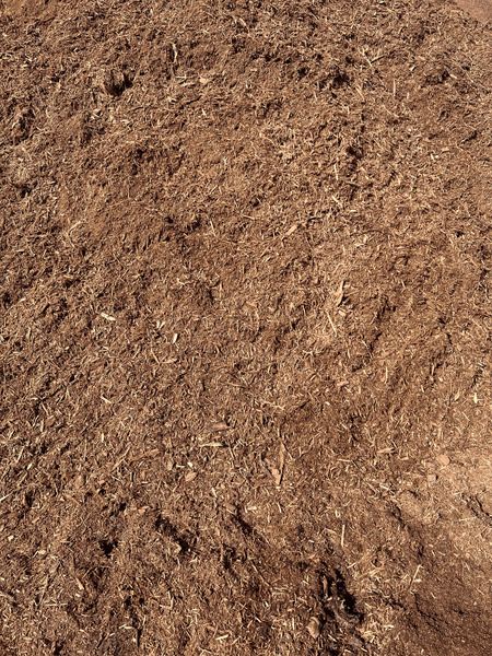 Brown mulch, finely shredded wood material, covering a surface.