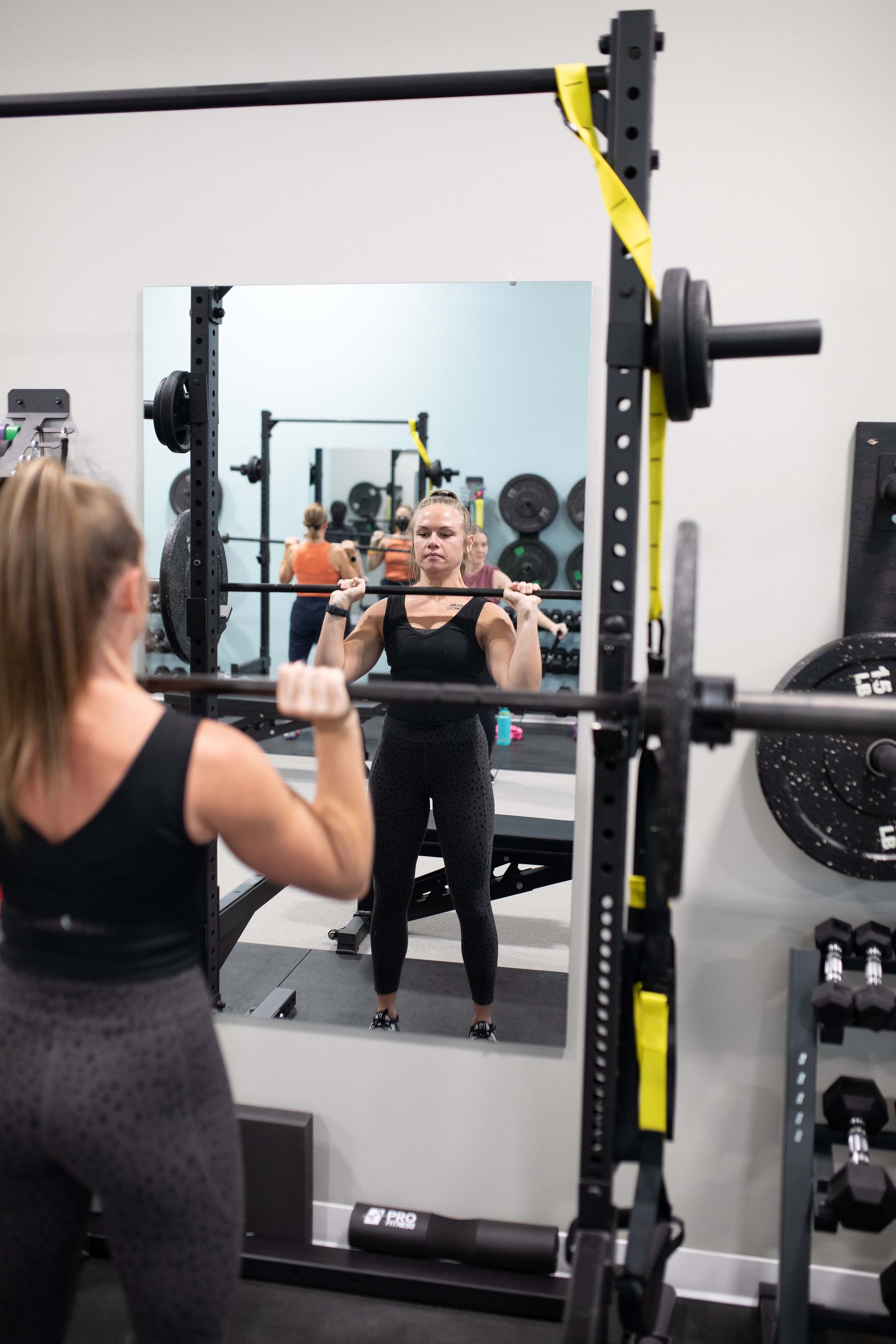 A woman lifting a barbell with a proper position
