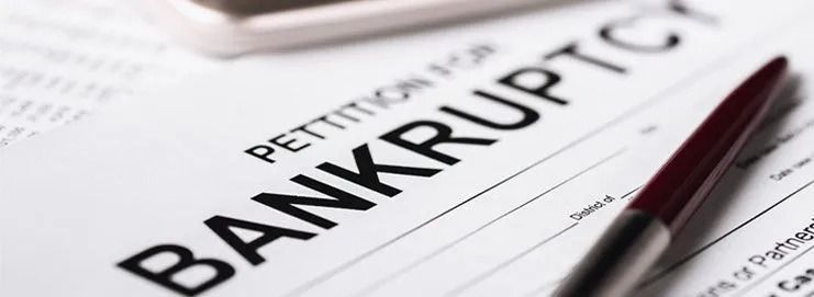 Bankruptcy document with a pen lying across the page