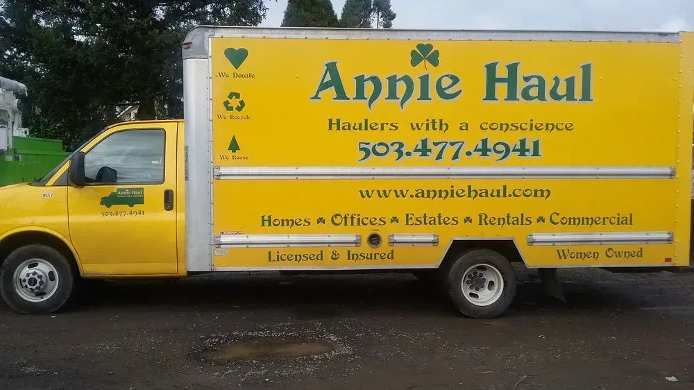 Yellow Annie Haul moving truck with contact info on side.