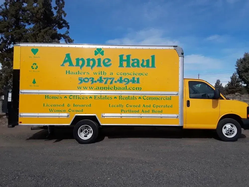 Yellow Annie Haul moving truck parked outdoors with logo and phone number visible.
