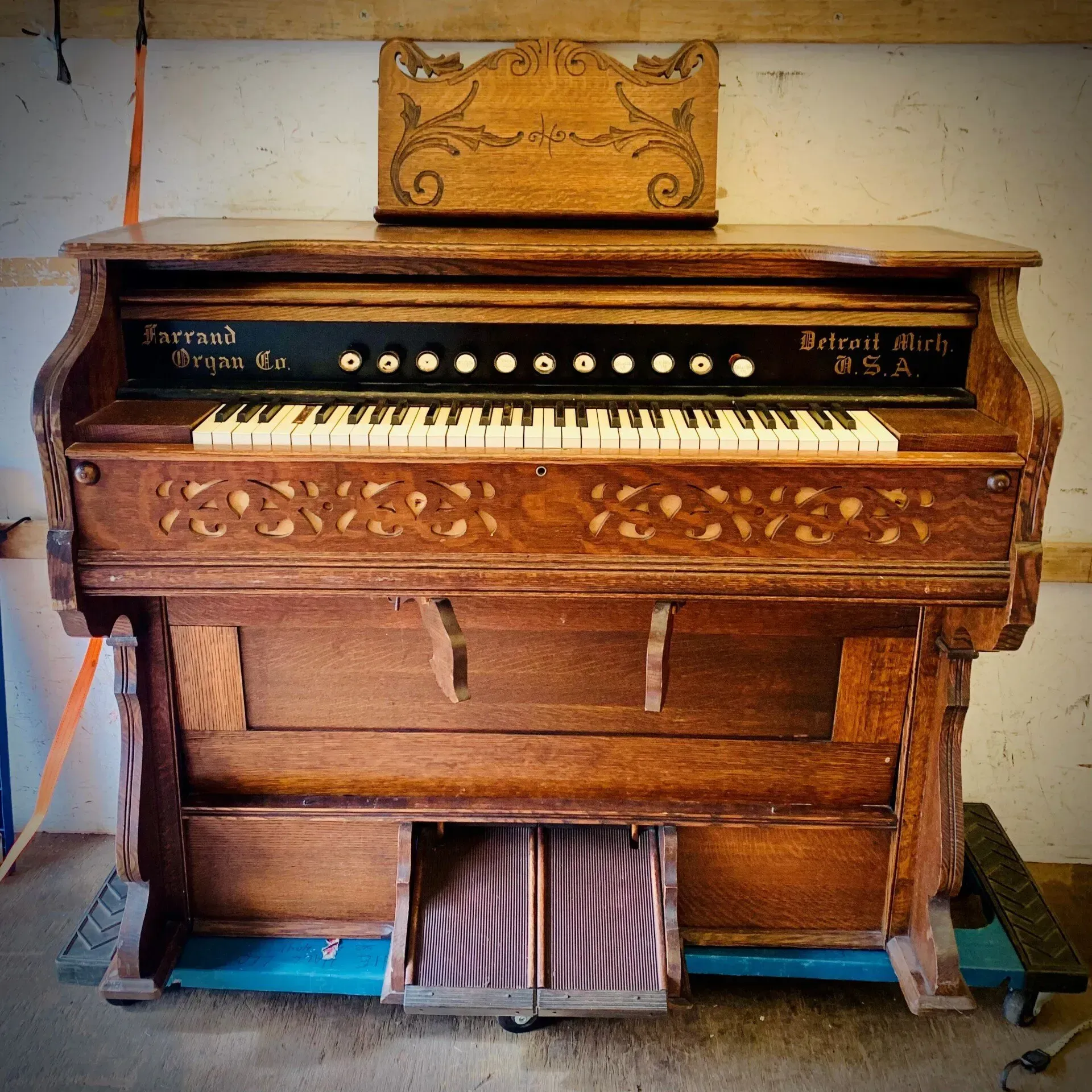 Antique reed organ, brown wood, floral carvings, Detroit Michigan, USA.