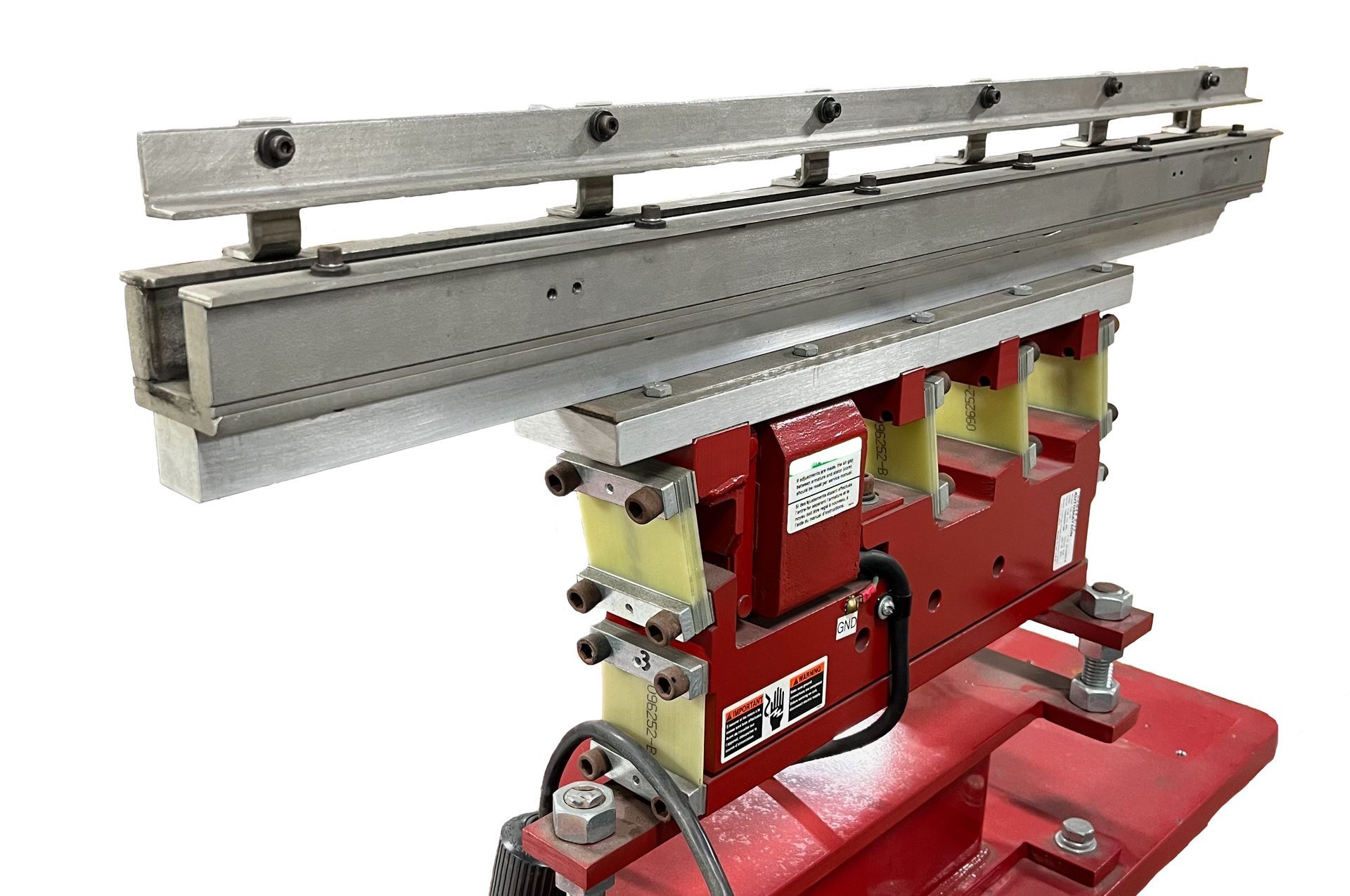 Red industrial machine with a long silver rail mounted on a red base