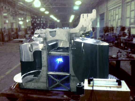 A machine in a factory with a blue light coming out of it
