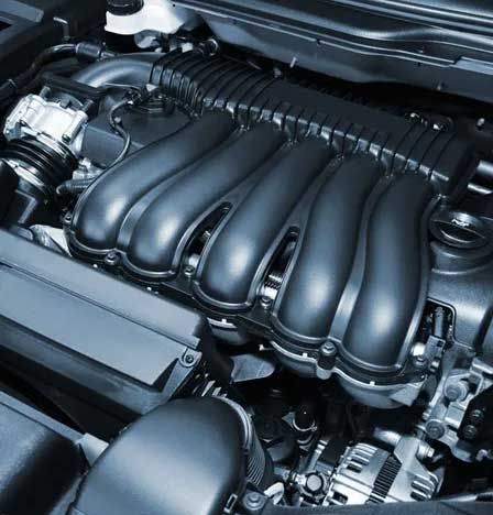 Car engine, black intake manifold, various components visible.