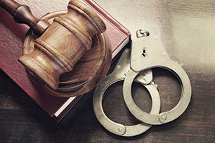 Handcuffs, gavel and law book