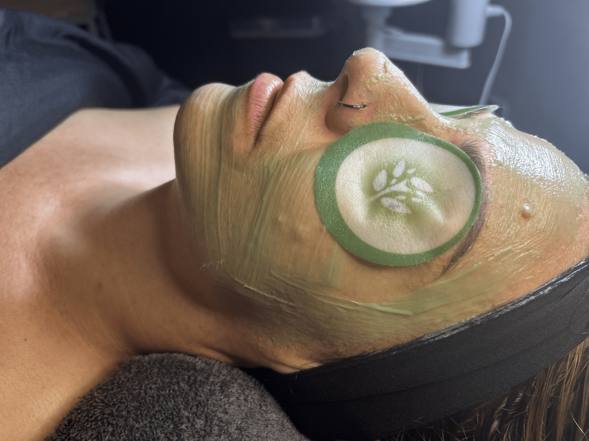 A woman with a cucumber slice on her eye