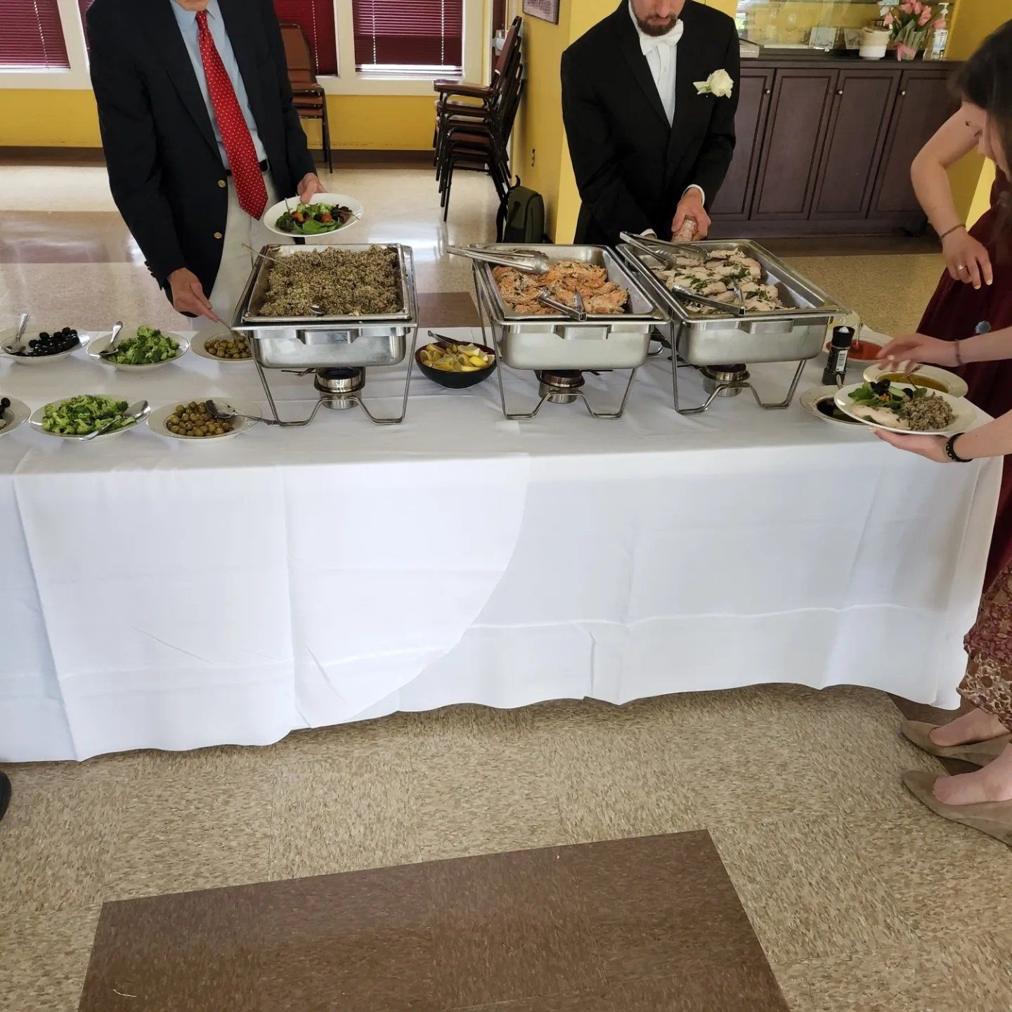 Men getting olives on a dish tray