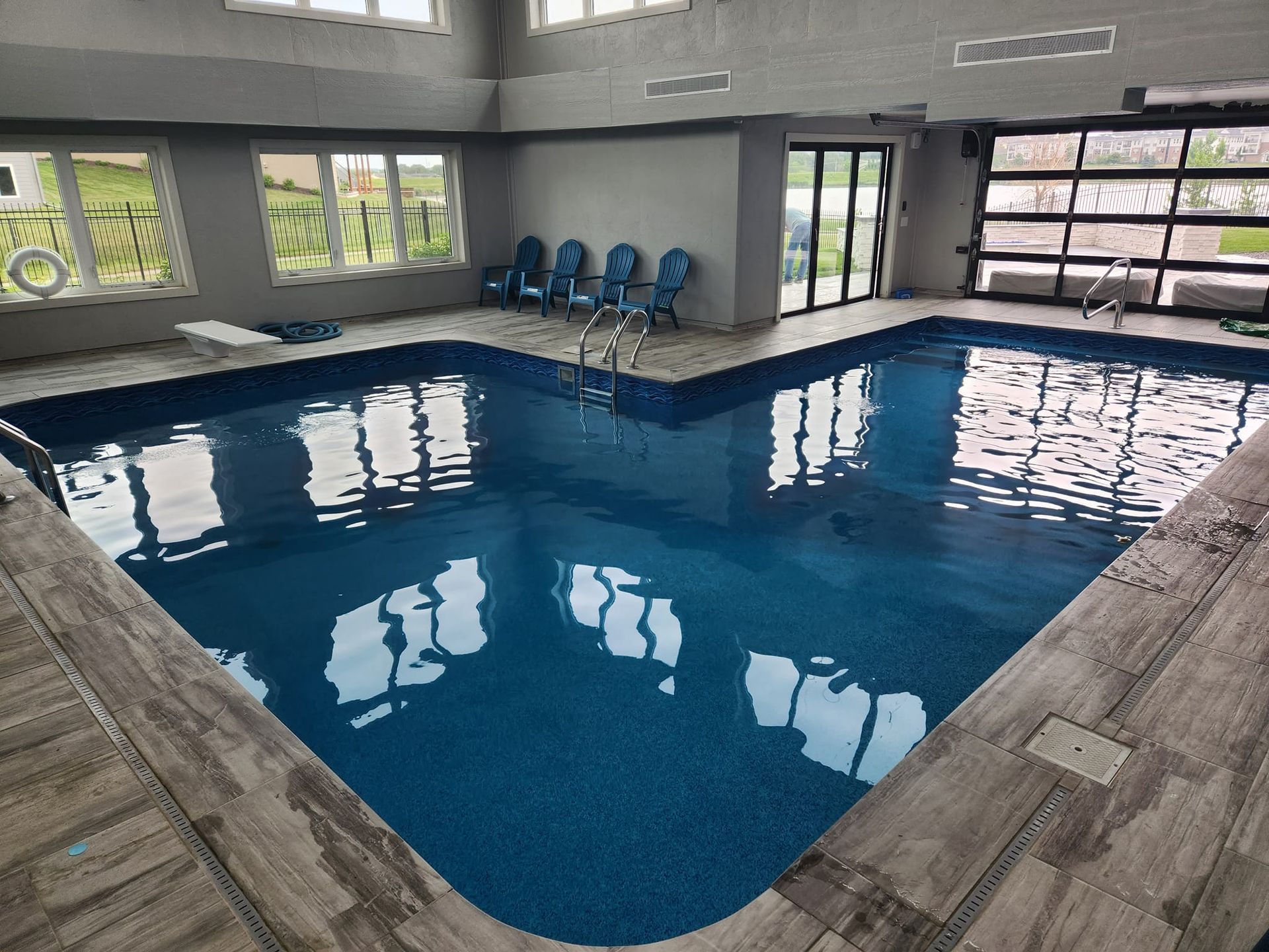 A large indoor swimming pool with a lot of windows