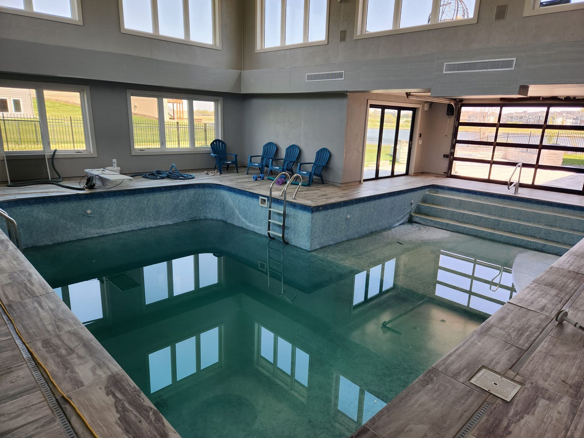 A large indoor swimming pool is being built in a building.