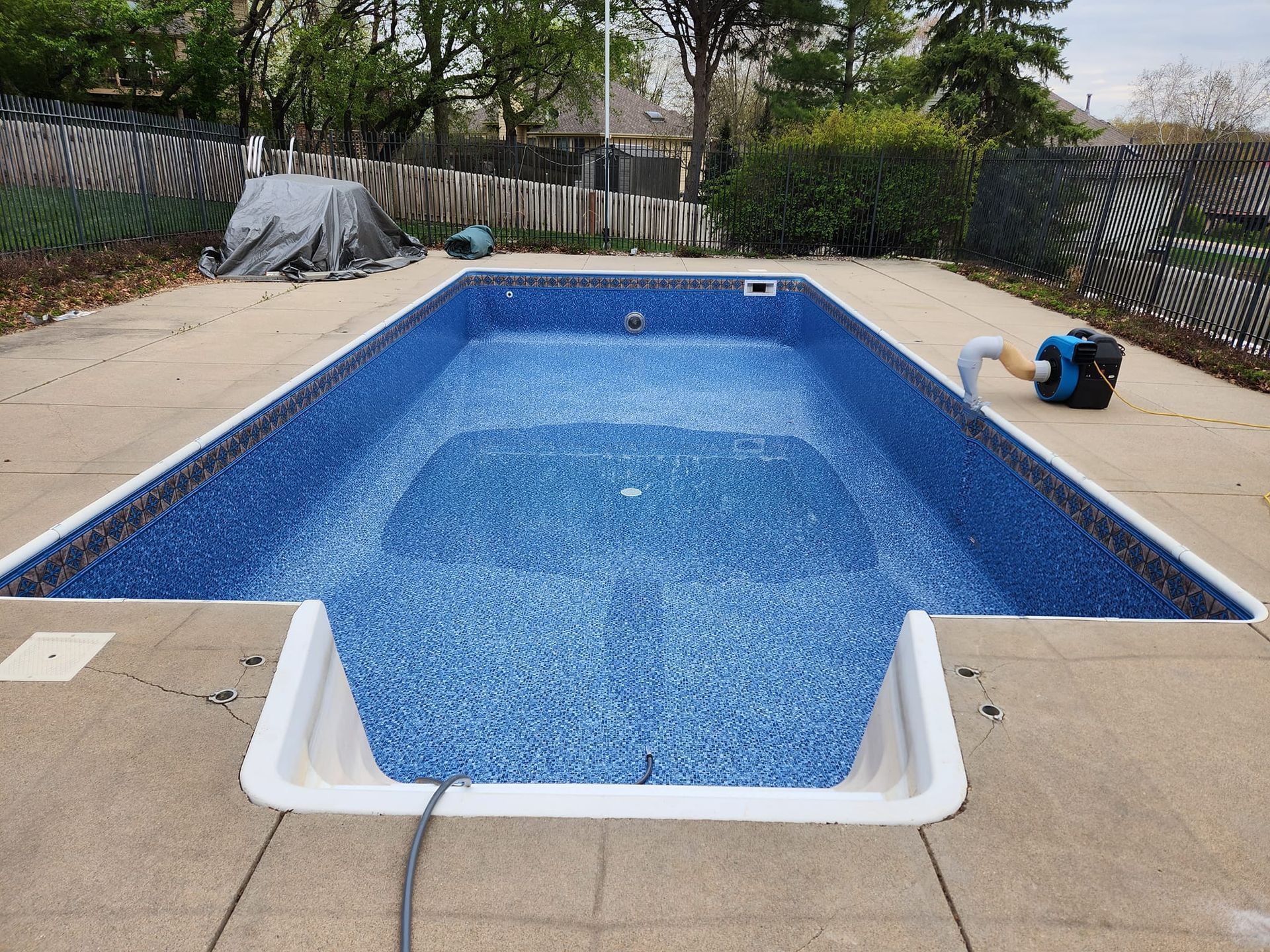 A large swimming pool is being filled with water.