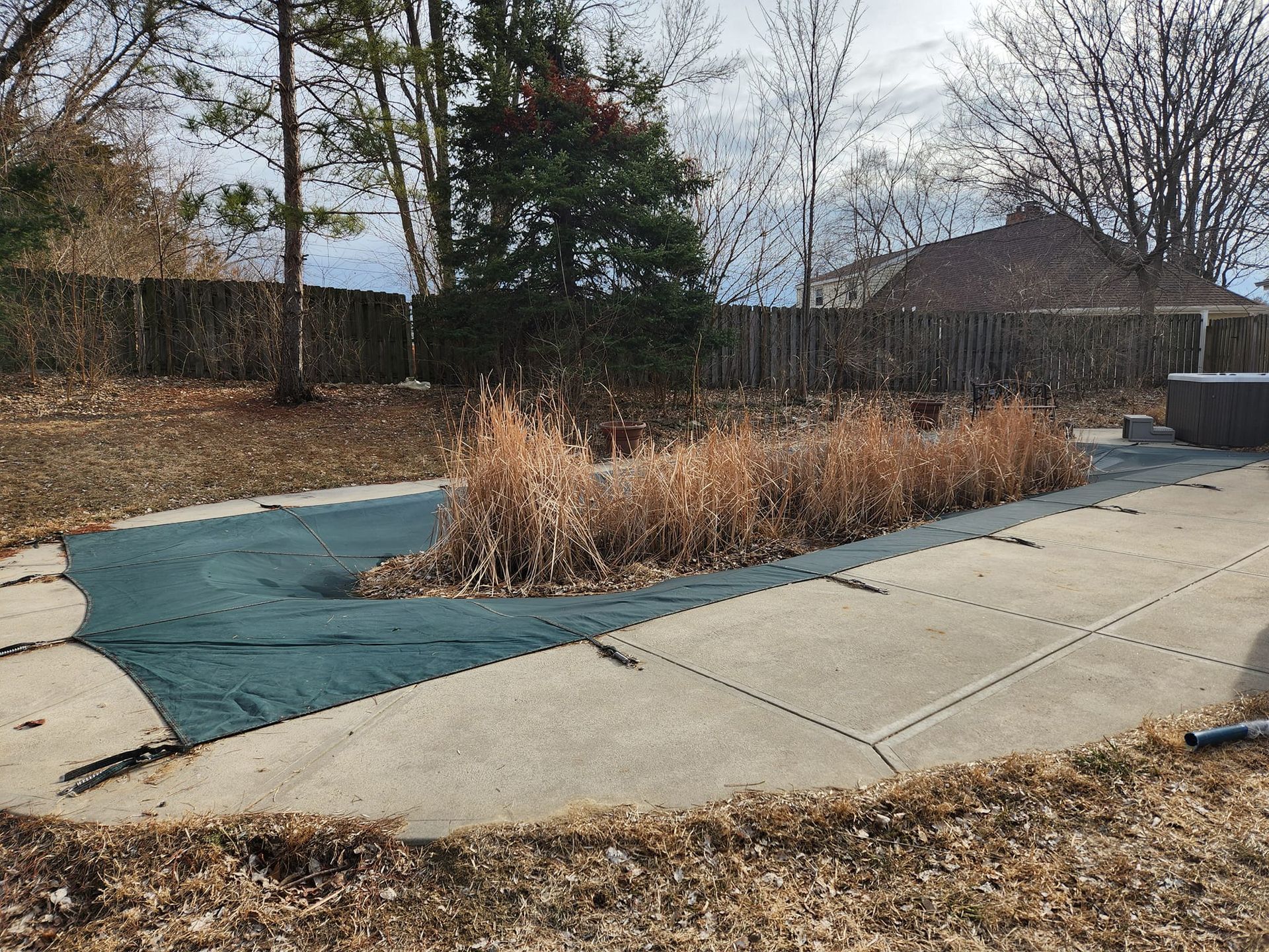 A swimming pool with a green cover on it