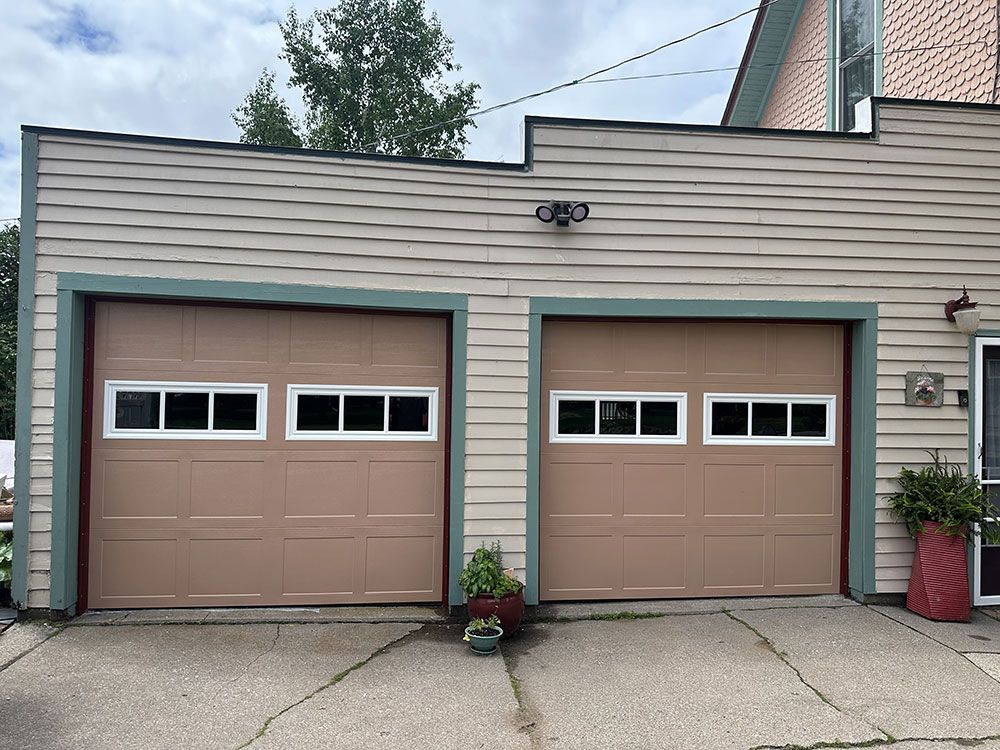 A house with two garage doors on the side of it