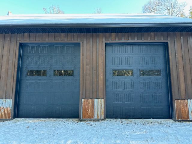 A garage with two garage doors in the snow.