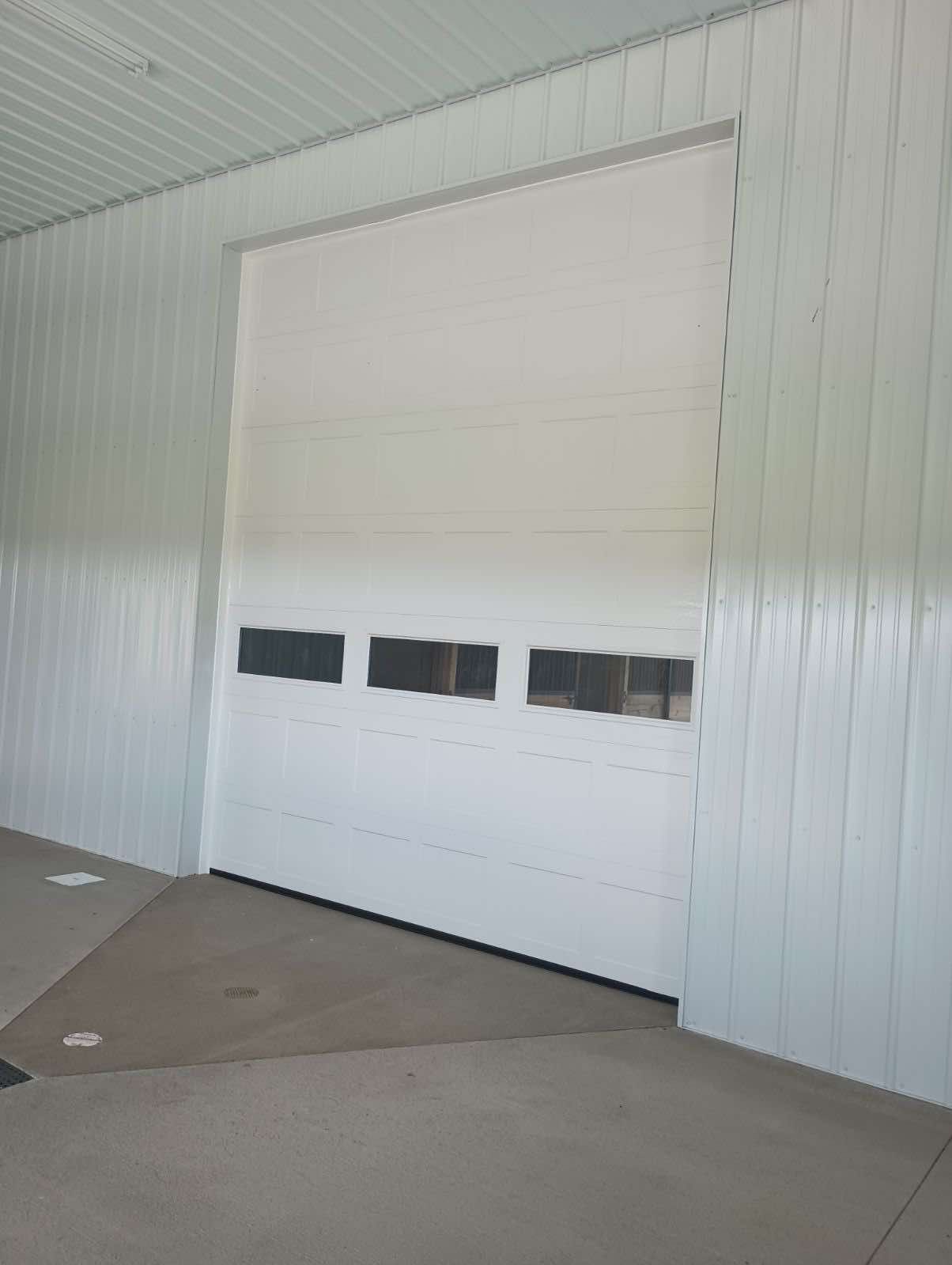 A white garage door with a lot of windows on it