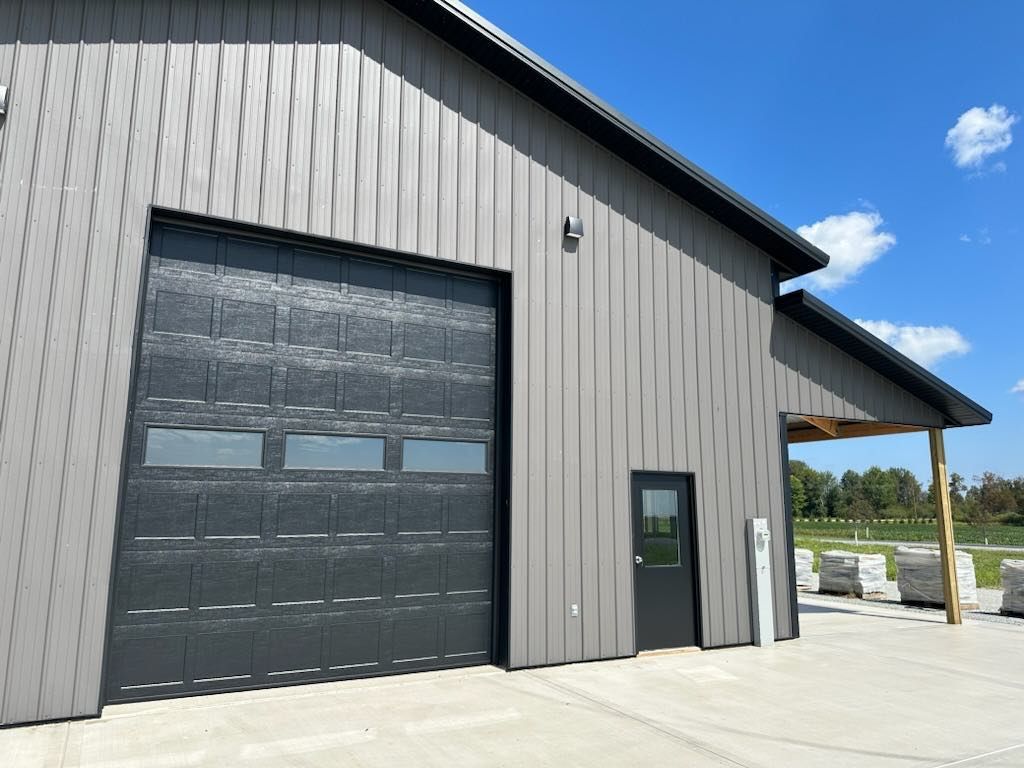 A large garage door is open on the side of a building.