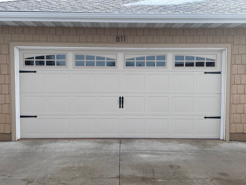A white garage door with the number 411 on it