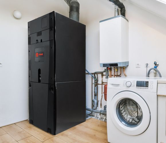 A laundry room with a washer and dryer and a heater