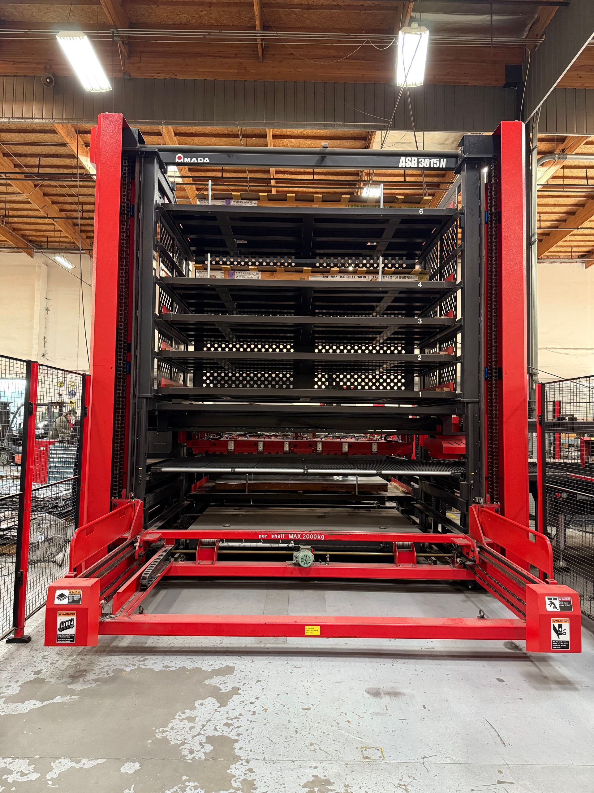 Red and black automated storage system in a warehouse setting.