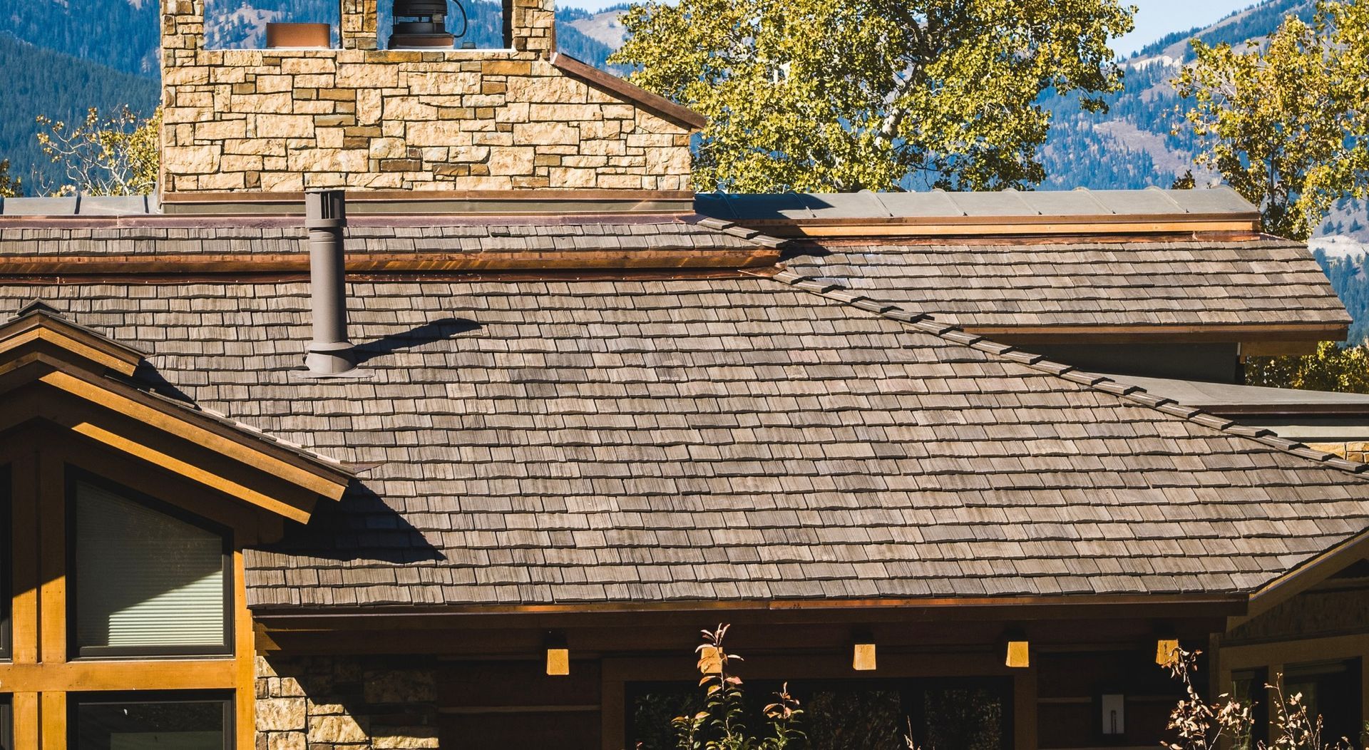 A house with a wooden roof and a stone chimney.