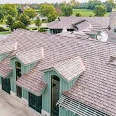 An aerial view of a large house with a Brava roof.