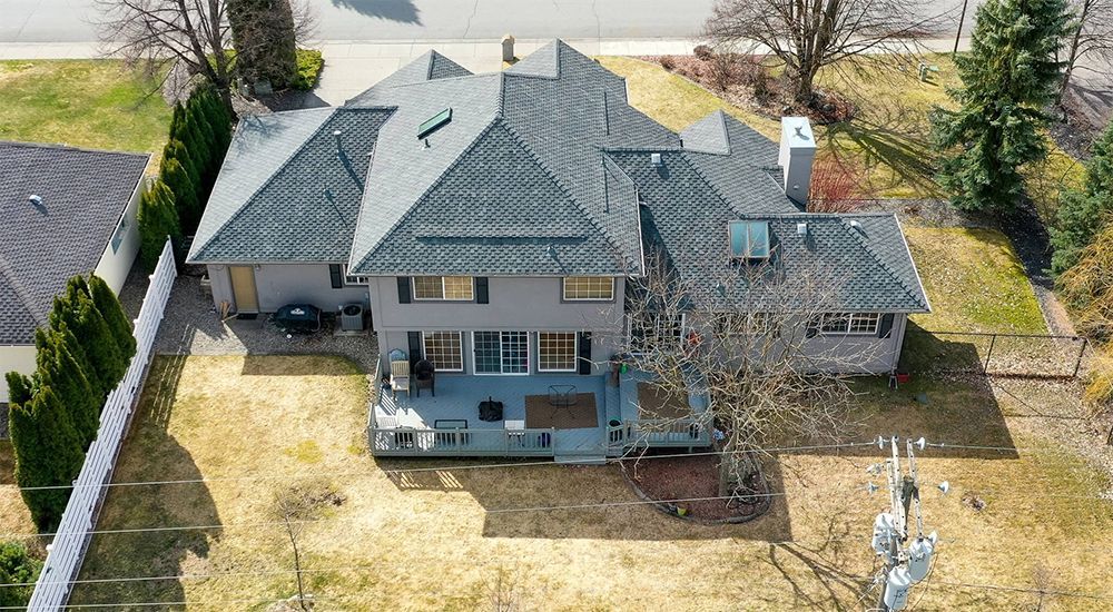 An aerial view of a large house with a large lawn in front of it