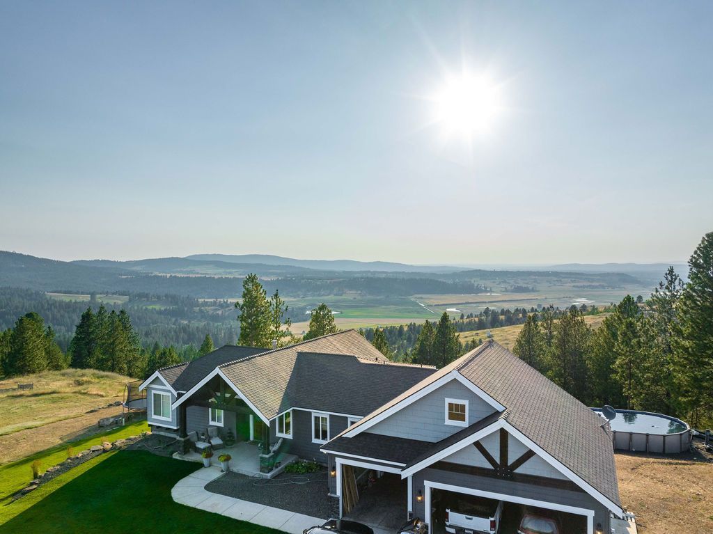 An aerial view of a large house on top of a hill