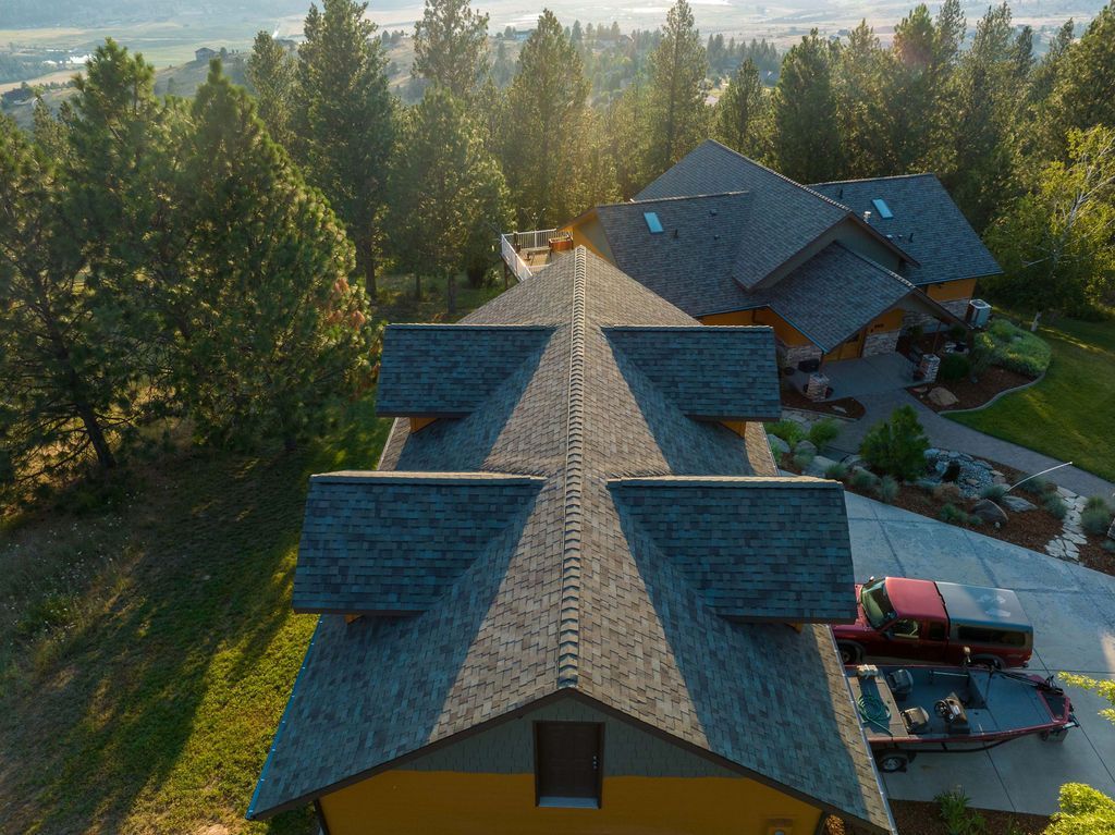 An aerial view of a large house surrounded by trees