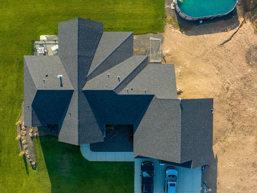 An aerial view of a house with a pool in the backyard