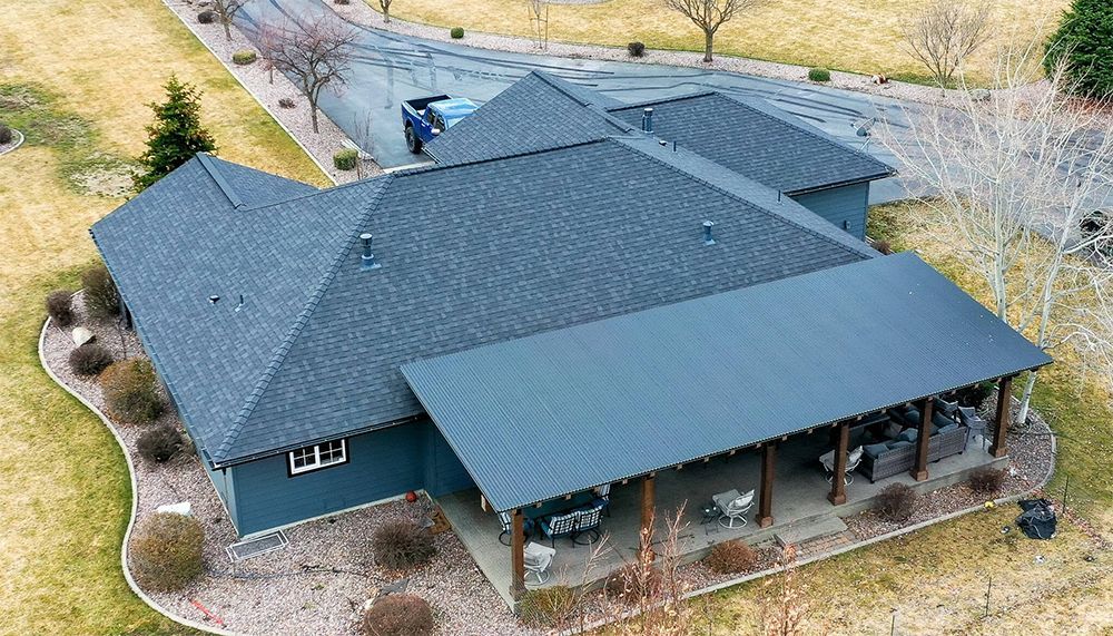 An aerial view of a large house with a covered porch