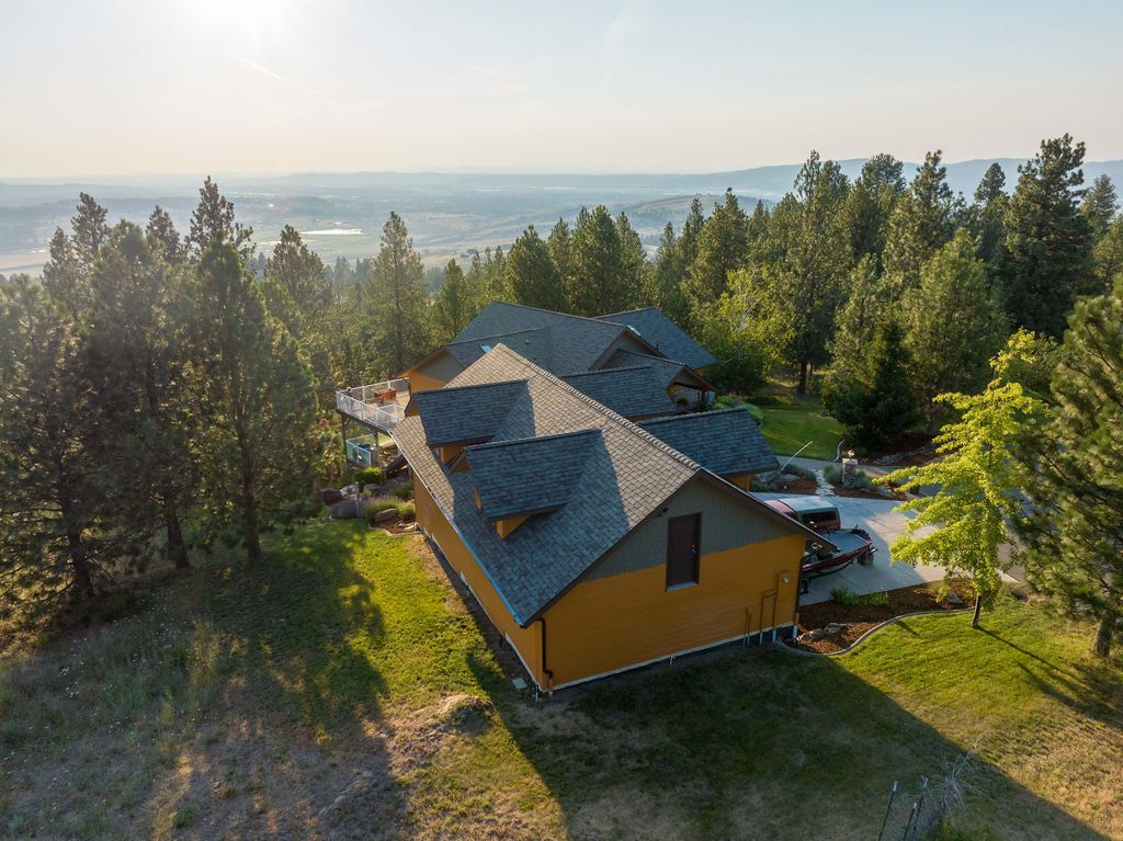An aerial view of a house in the middle of a forest