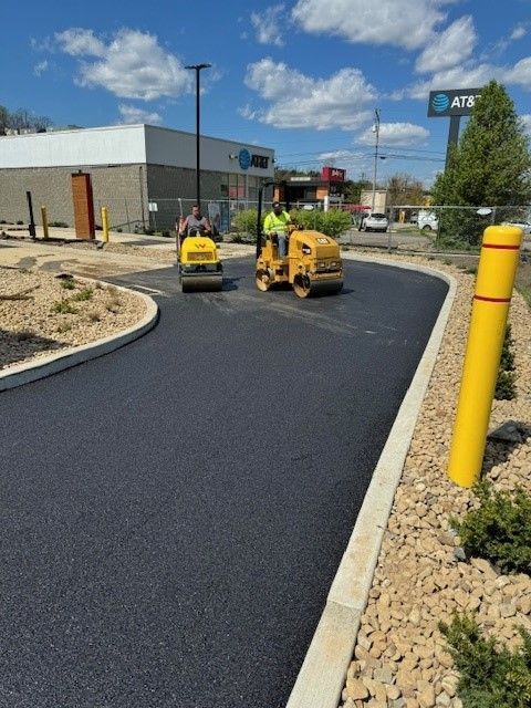 a road is being paved next to an AT&T store