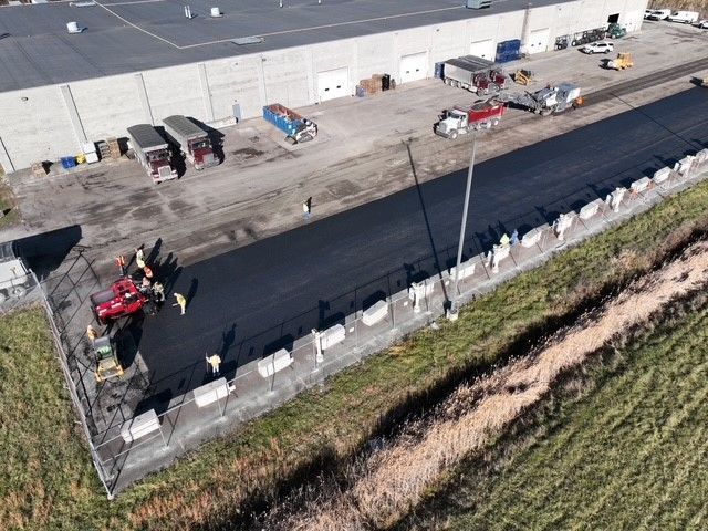 an aerial view of a lot being paved with asphalt