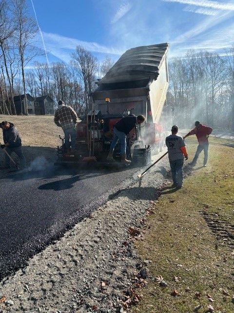 A group of people are working on a road.