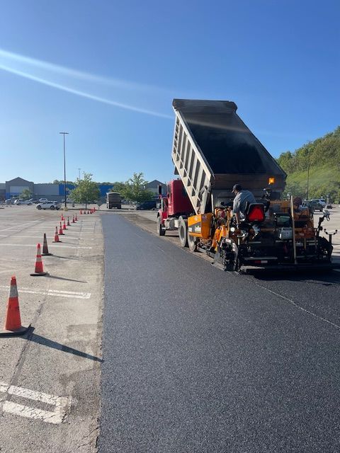 a dump truck loaded with asphalt