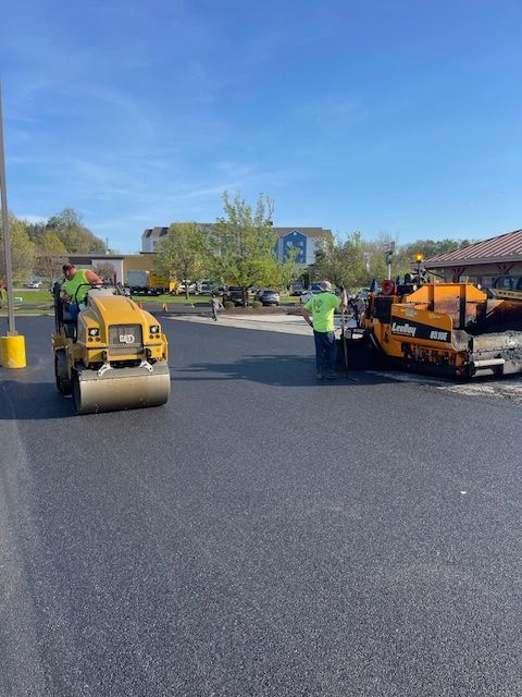 asphalt rollers working on a road