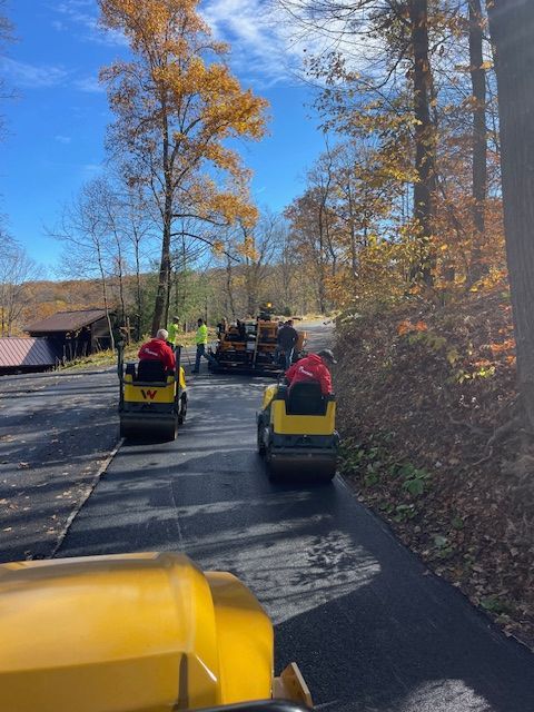 a group of people are riding asphalt roller