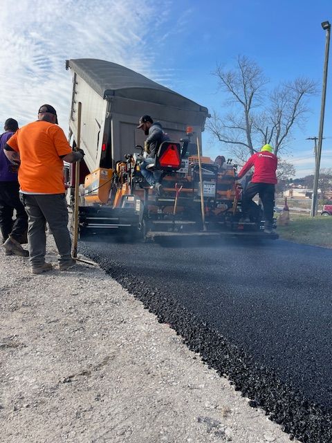 a group of people are working on a road