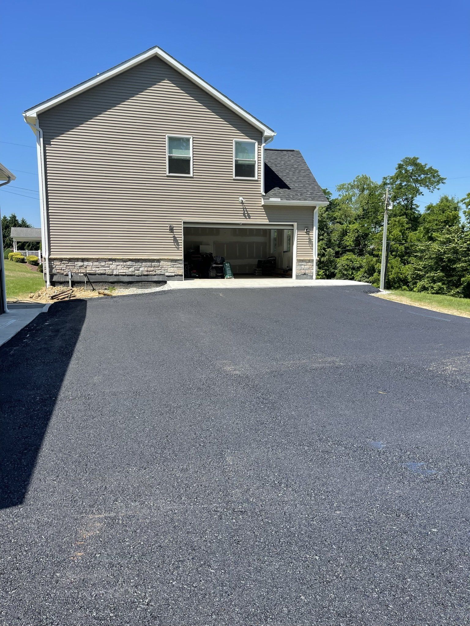 A house with a garage and a driveway in front of it.