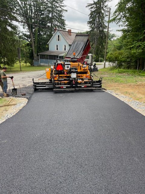 spreading asphalt on a road