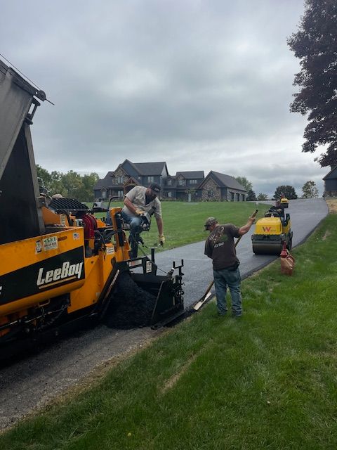 a group of men are working on a road