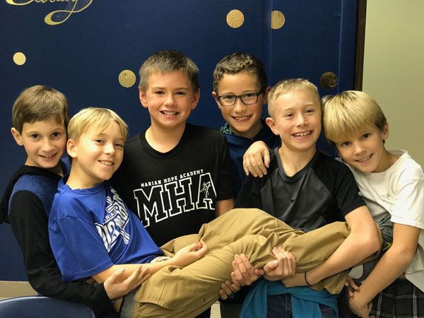 A group of young boys are posing for a picture.