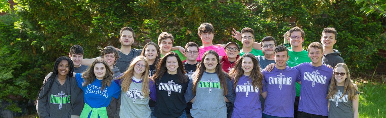 A group of young people are posing for a picture together.